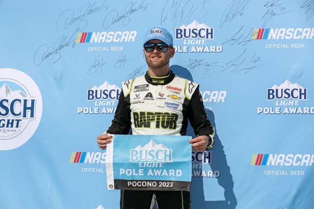 Jul 22, 2023; Long Pond, Pennsylvania, USA; NASCAR Cup Series driver William Byron stands with the Busch Light Pole Award after winning the pole for the HighPoint.com 400 at Pocono Raceway.