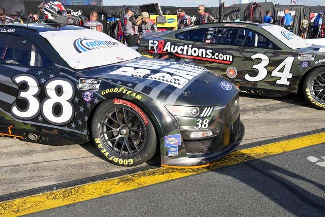 May 28, 2022; Concord, North Carolina, USA; The cars of NASCAR Cup Series driver Todd Gilliland (38) and driver Michael McDowell (34) sport military color schemes during Nascar Cup Practice at Charlotte Motor Speedway.