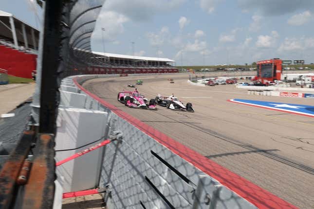 Jul 22, 2023; Newton, Iowa, USA; Team Penske driver Josef Newgarden (2) of United States and Meyer Shank Racing driver Conor Daly (60) of United States lead traffic down the front stretch during the Hy-Vee Homefront 250 at Iowa Speedway.